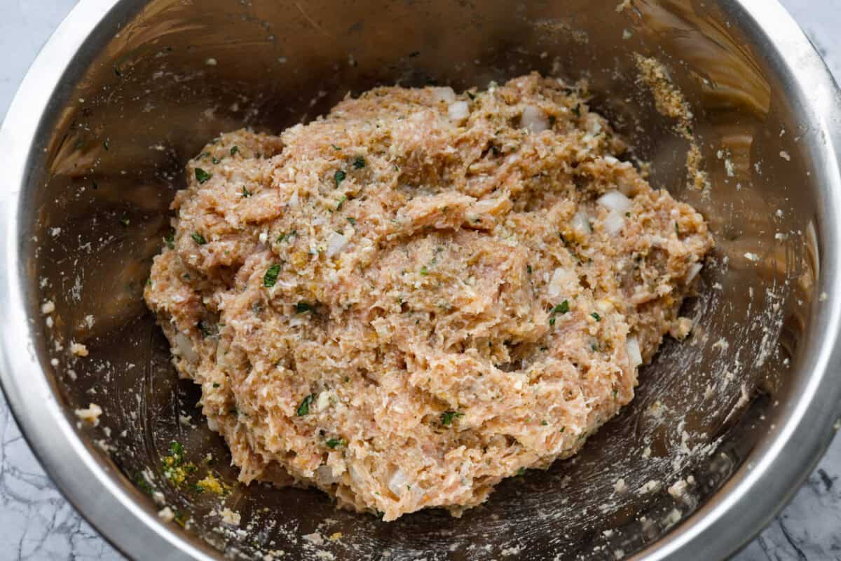 All of the meatloaf ingredients mixed together in a bowl.