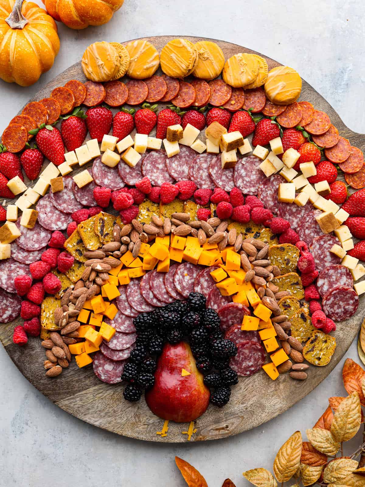 Charcuterie board with the ingredients laid out in the shape of a turkey. 