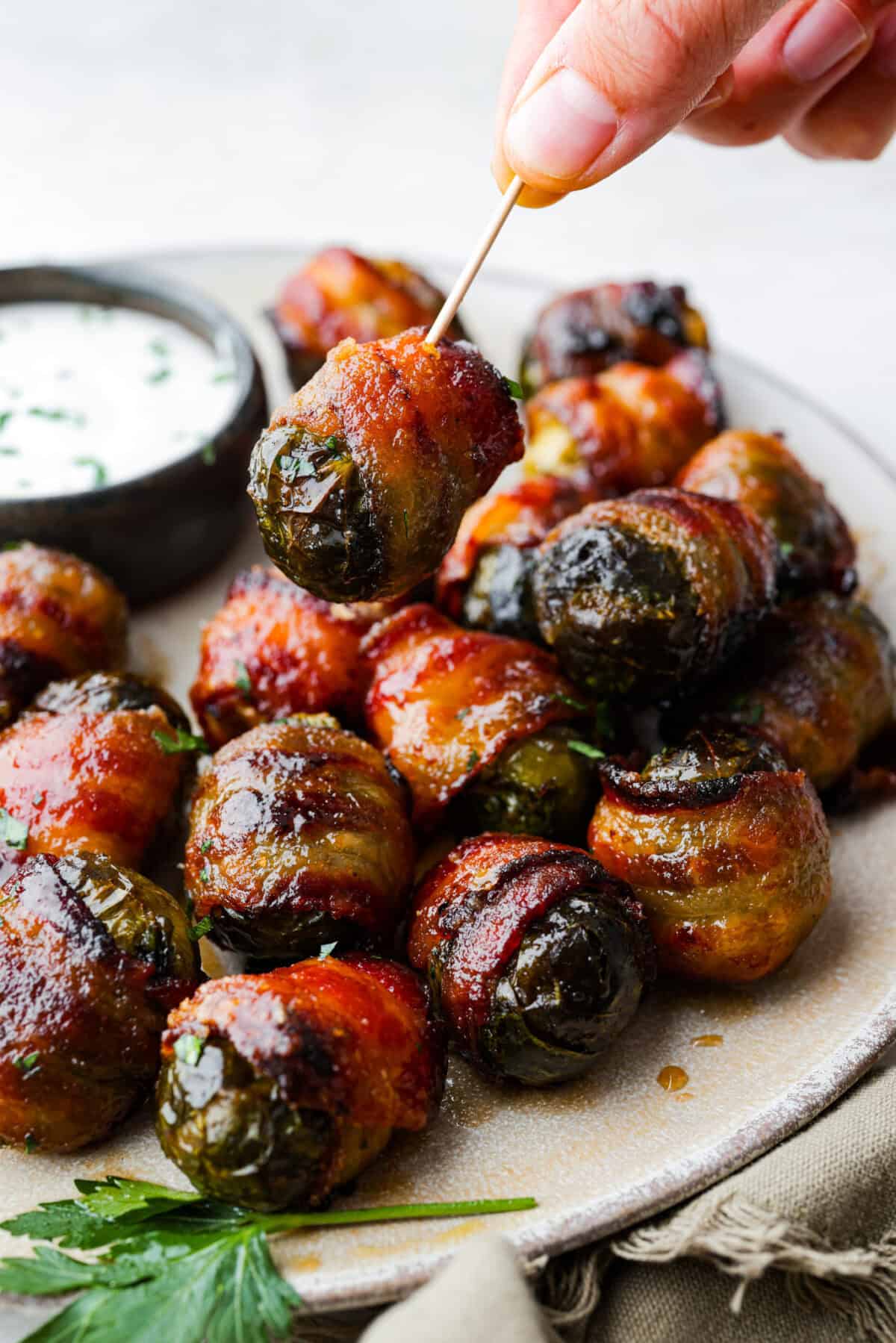 Atoothpick in a bacon wrapped brussel sprout. 