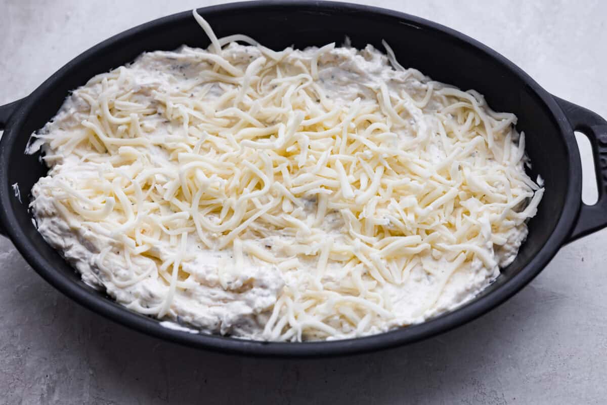 Cheesy garlic bread made into the dip of your dreams! This Garlic Bread Dip is full of roasted garlic and layers of melty cheese. It's irresistible from the very first bite! Mozzarella and parmesan cheese spread over the top of the dip.
