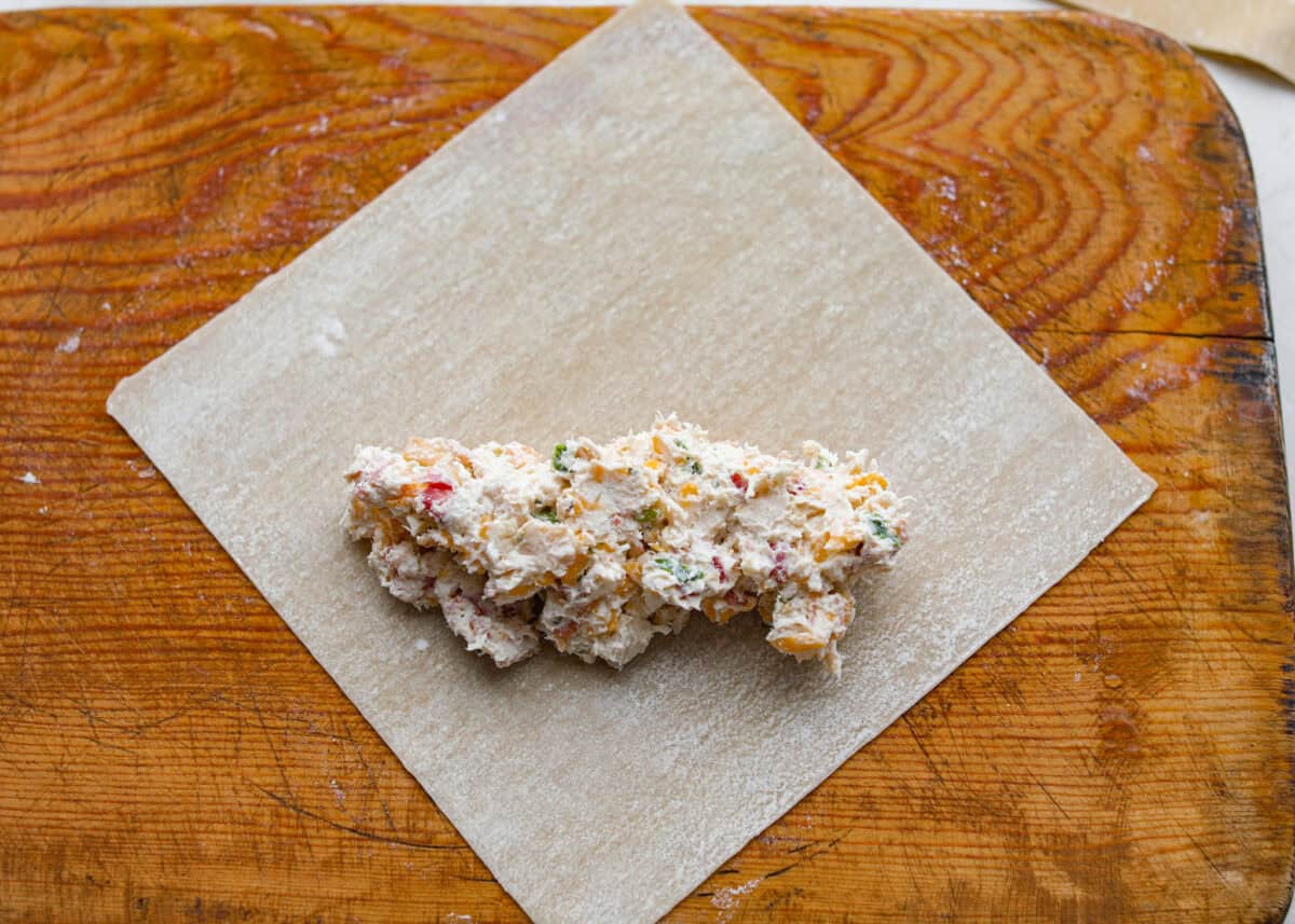 Egg roll wrapper with a scoop of filling on it.