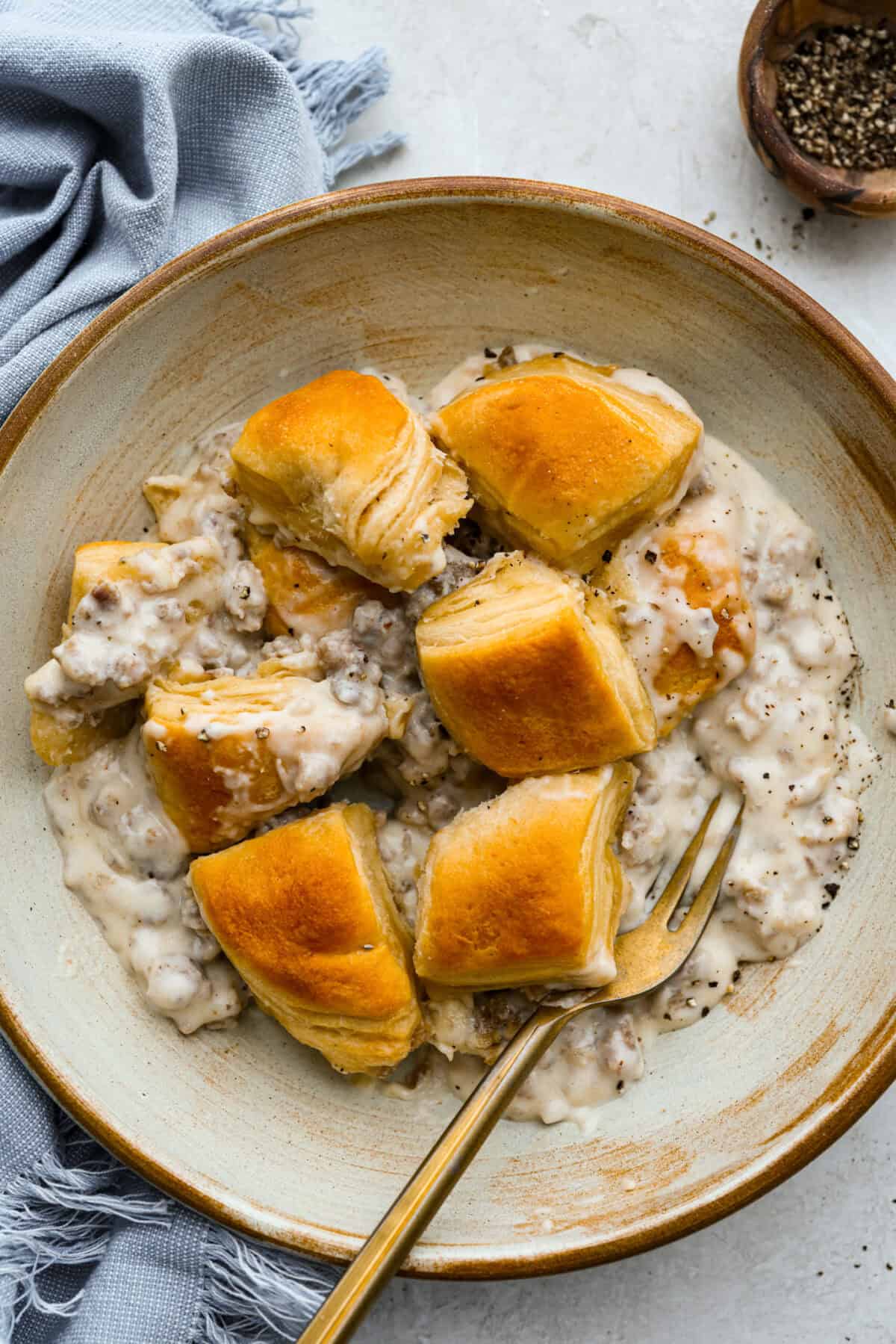 Bowl with a serving of biscuits and gravy casserole.