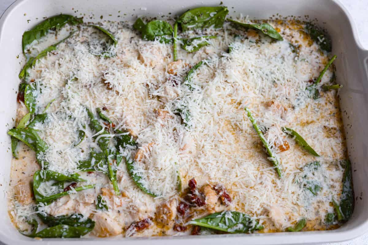 All of the ingredients stirred together and covered with parmesan cheese. 