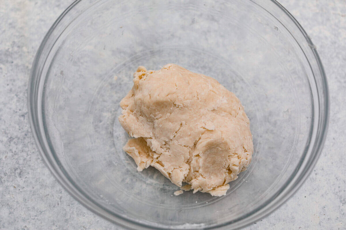 Water and shortening added to the dry ingredients and mixed together to form a dough. 