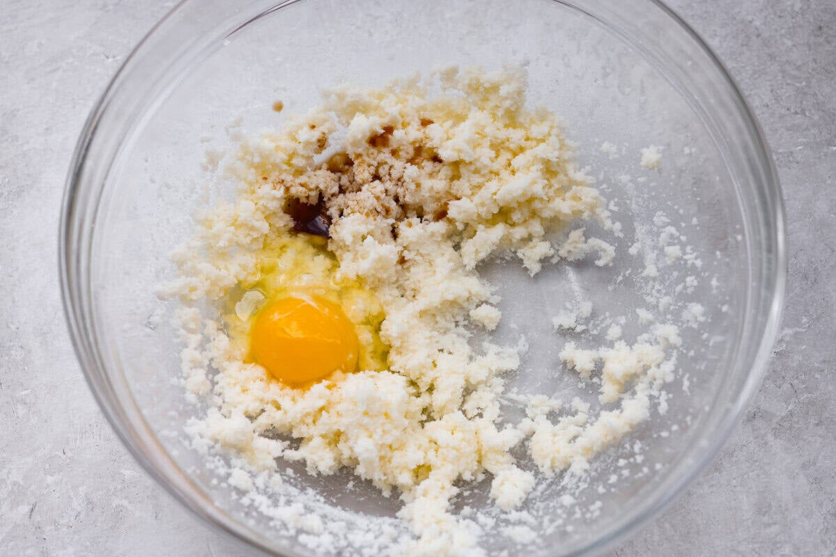 Bowl of creamed sugar and butter with and egg and both extracts added.