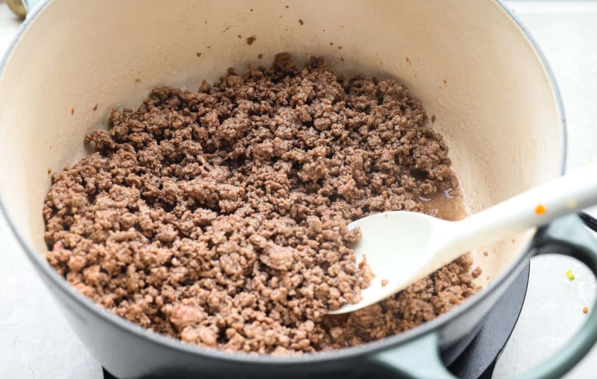 If groceries feel higher than ever, you’re not alone. That’s why I love hobo stew. It's cozy, hearty, and made from whatever’s in the pantry. It turns simple ingredients into a meal everyone will love. Ground beef cooking in a dutch oven.