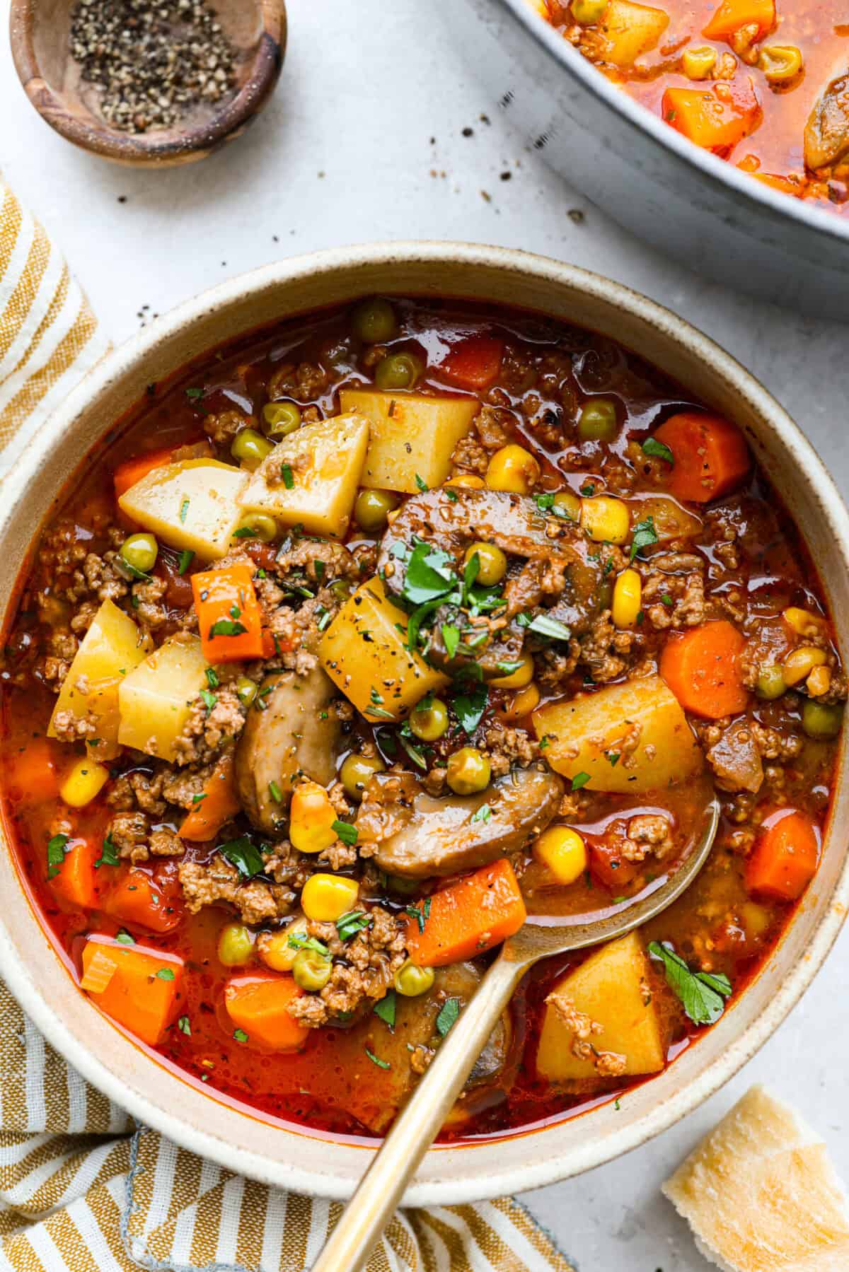 If groceries feel higher than ever, you’re not alone. That’s why I love hobo stew. It's cozy, hearty, and made from whatever’s in the pantry. It turns simple ingredients into a meal everyone will love. Bowl of hobo stew with gold spoon.