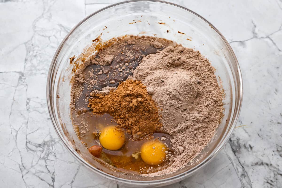 Whet and dry ingredients added together in a mixing bowl.