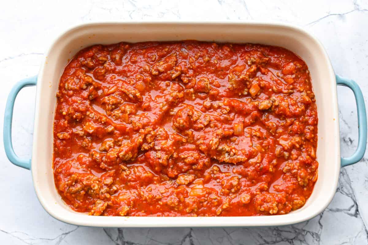 Marinara meat mixture added to the bottom of the baking dish. 