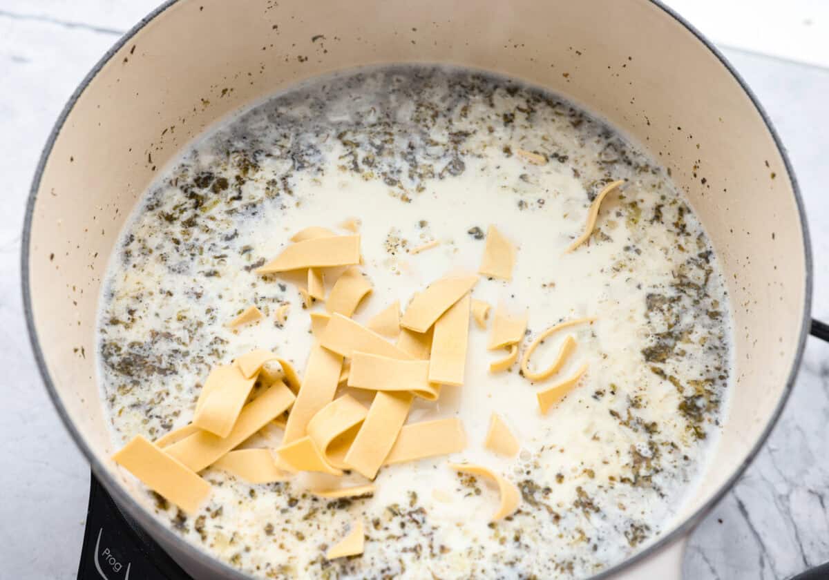 Dry noodles added to the pot to cook. 