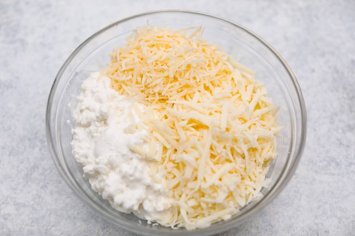 All three cheeses mixed together in a bowl. 