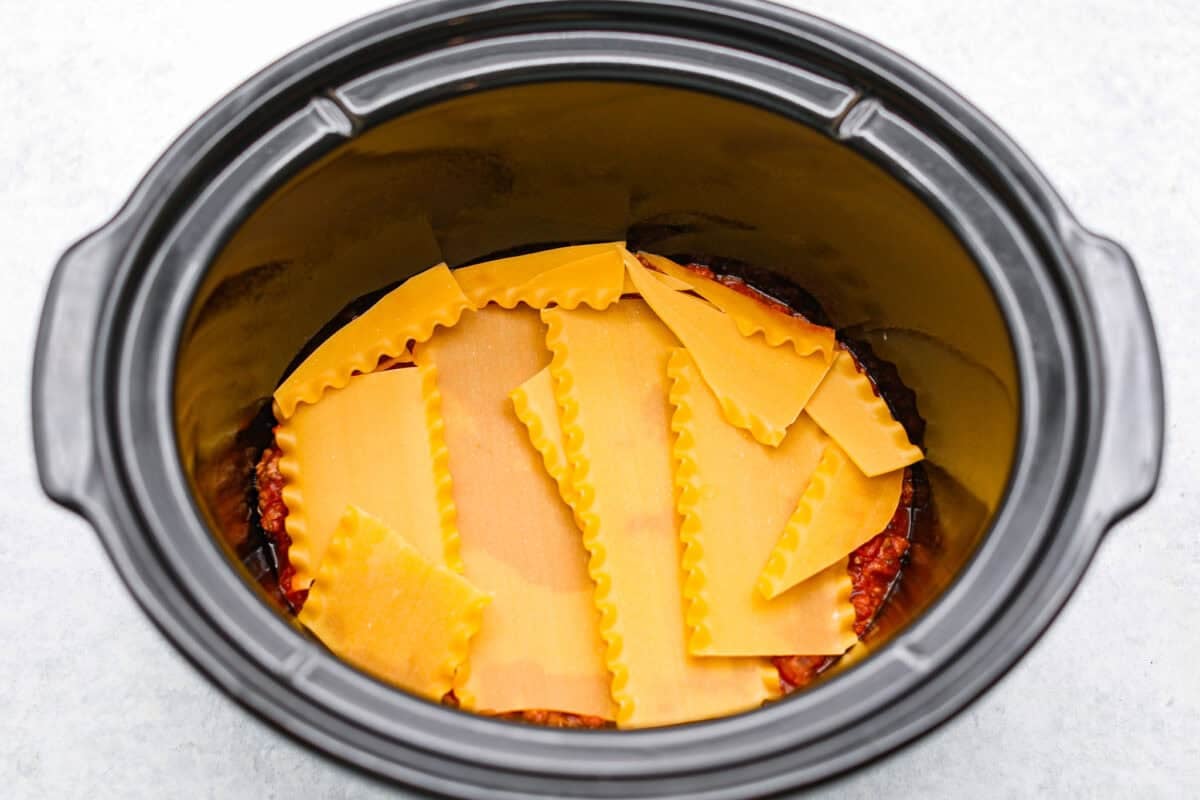 Lasagna noodles layered on top of the meat sauce. 