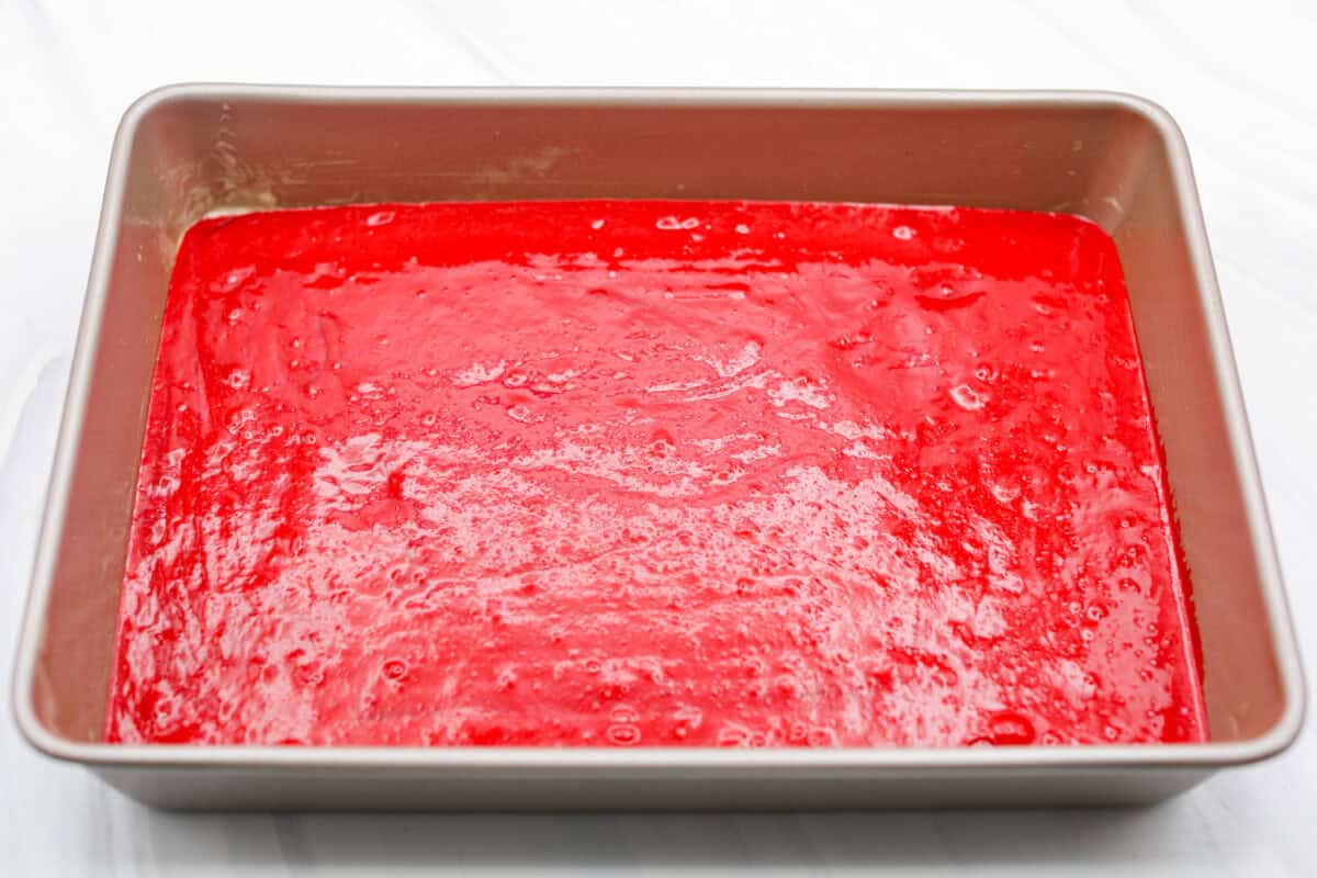 Cake batter poured into a cake pan ready to go into the oven.