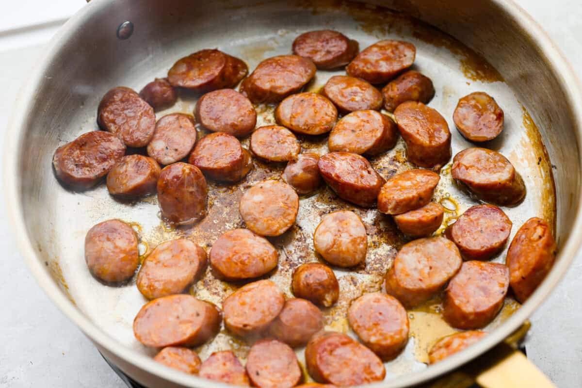 Sausage browning in a skillet.