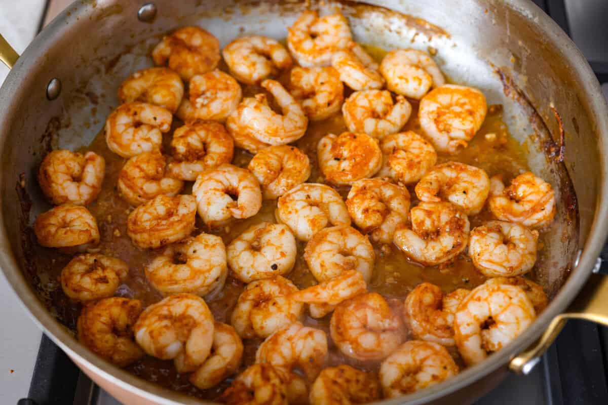 Shrimp cooking in a skillet.