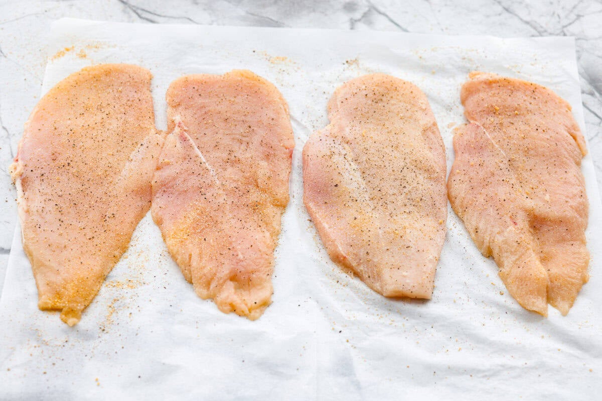 Flattened chicken breasts seasoned. 