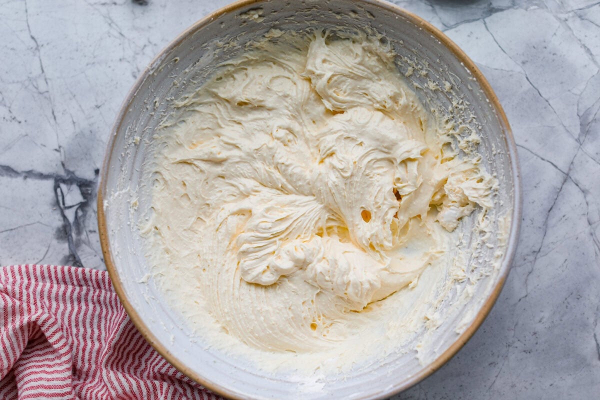 Fluff salads never go out of style. They're light, creamy, and just plain fun! This cherry cheesecake fluff is customizable and so easy to throw together! It's packed with sweet-tangy cheesecake flavor and juicy cherries in every bite. Cream cheese, pudding mix, and whipped topping all mixed together.