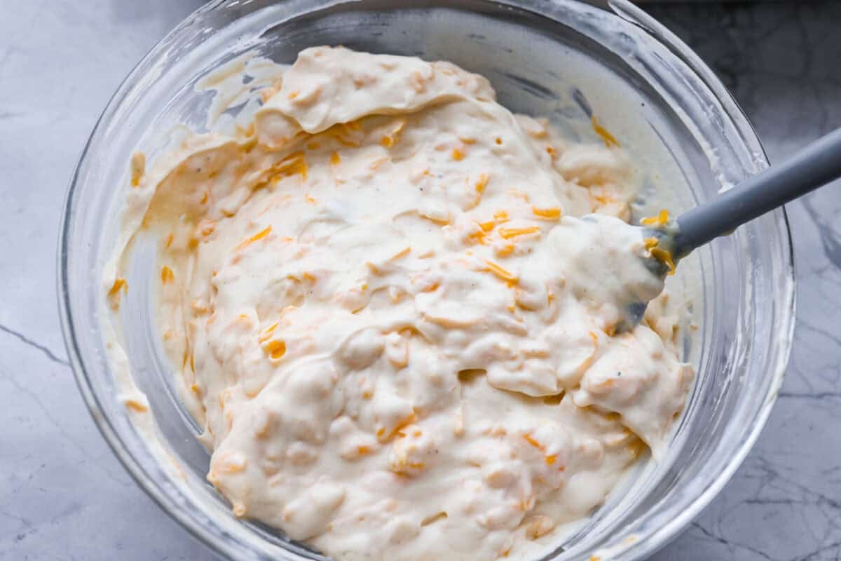 Chicken divan sauce mixed together in a bowl. 