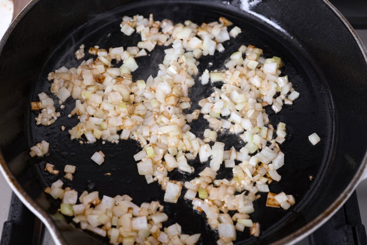 Onions cooking in a skillet.