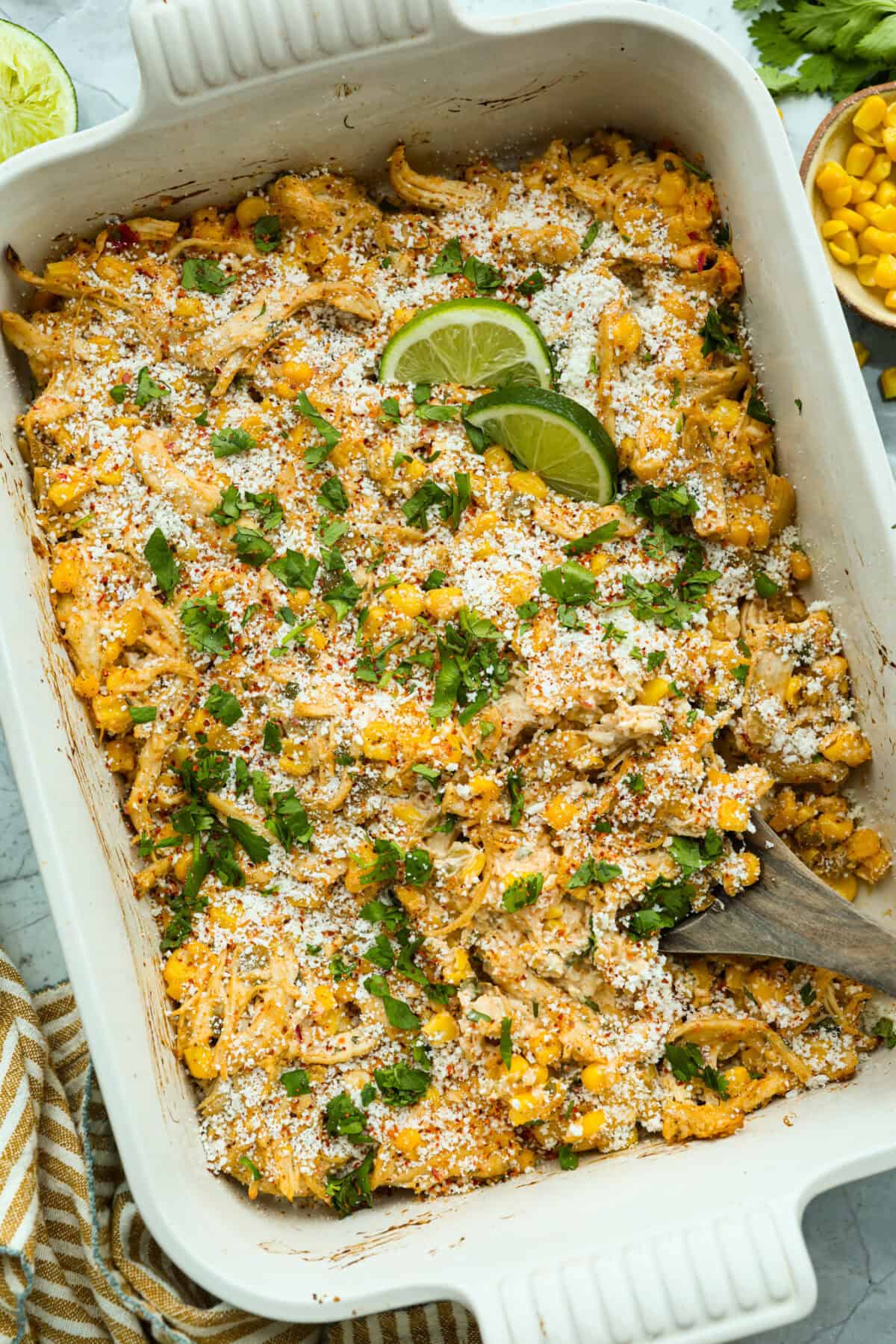 This Mexican Street Corn Chicken Casserole takes everything you love about elote, tangy lime, smoky Tajin, and creamy cotija, and turns it into one bubbly, cheesy weeknight dinner the whole family will devour! Top down shot of the Mexican street corn chicken casserole all ready to eat!